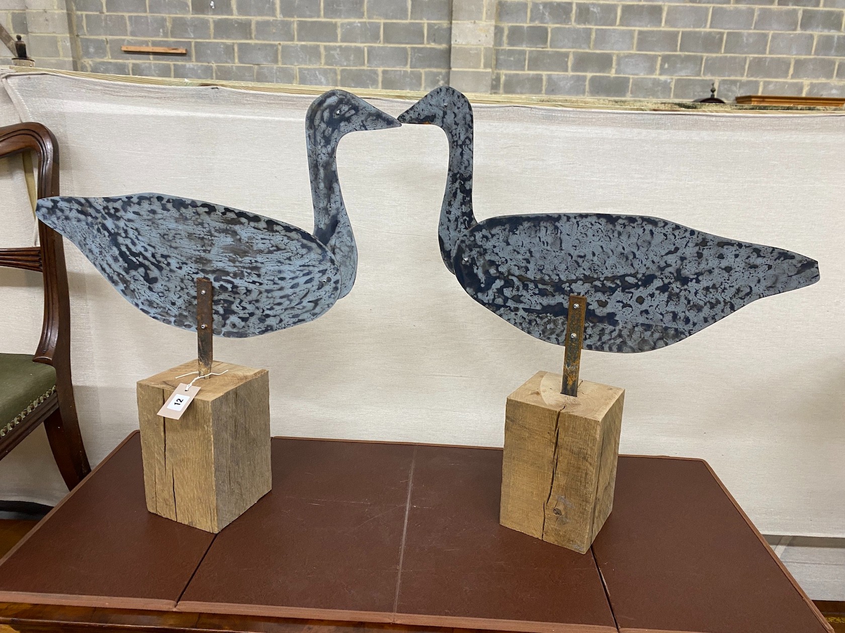A pair of white metal decoy geese, with articulated necks, width 55cm, height 69cm
